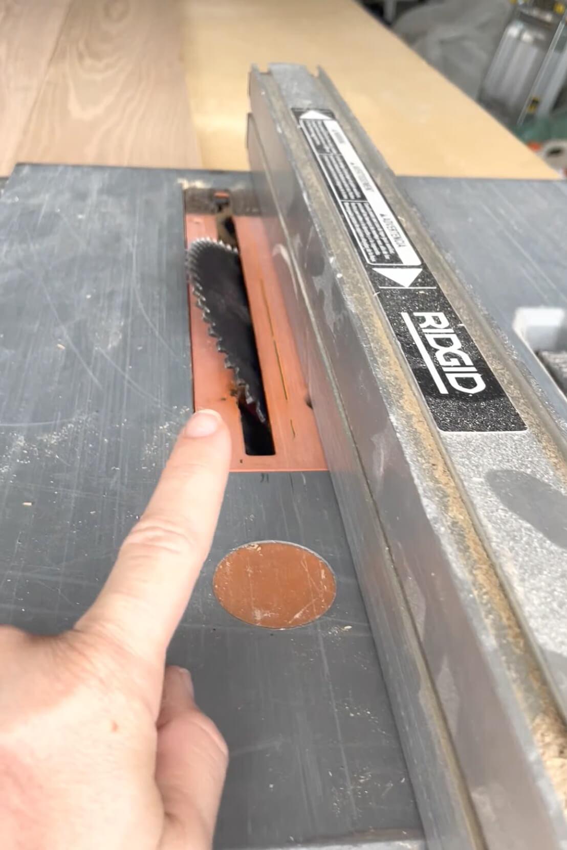 Using a table saw to make beveled edges on wood for building a fireplace mantel.